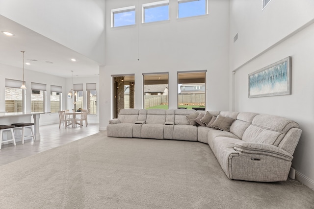 carpeted living area featuring recessed lighting, tile patterned floors, visible vents, and a wealth of natural light