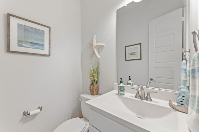 bathroom with toilet and vanity