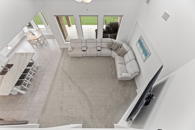 living area featuring baseboards and visible vents