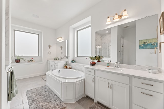 bathroom with visible vents, a stall shower, a sink, and a wealth of natural light