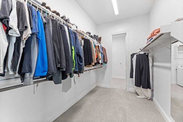 spacious closet with carpet floors and washer / clothes dryer