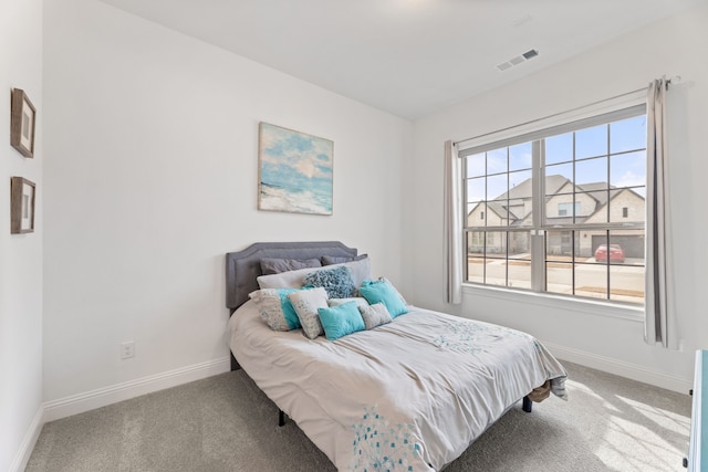 bedroom with carpet, visible vents, and baseboards