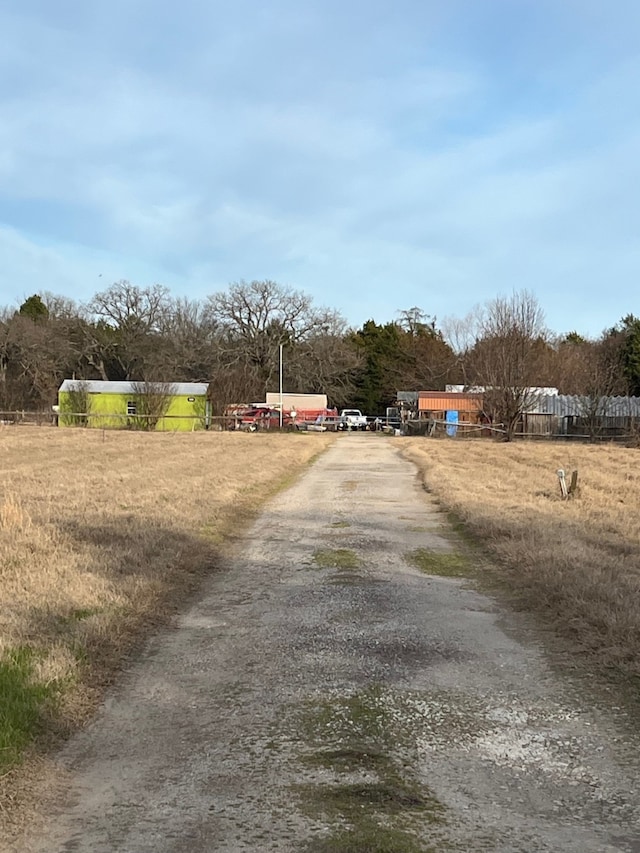 view of road featuring a rural view and driveway