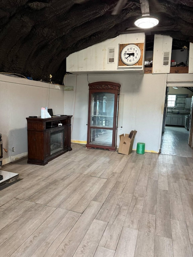 601 Pritchett Ln, Kemp, TX 75143 - unfurnished living room featuring wood finished floors, a fireplace, baseboards, and lofted ceiling