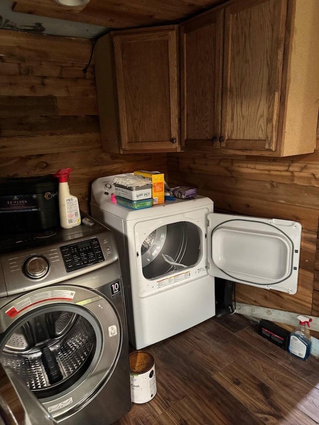 601 Pritchett Ln, Kemp, TX 75143 - laundry area featuring cabinet space, washing machine and clothes dryer, wooden walls, and dark wood-style flooring