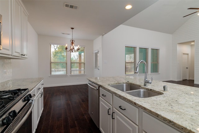 kitchen with appliances with stainless steel finishes, visible vents, white cabinets, and a sink