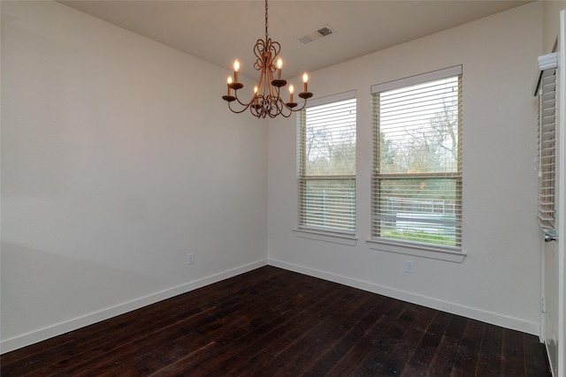 unfurnished room featuring baseboards, plenty of natural light, visible vents, and dark wood-style flooring