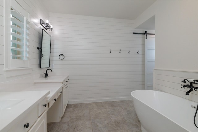 bathroom with a soaking tub, a sink, wood walls, and double vanity