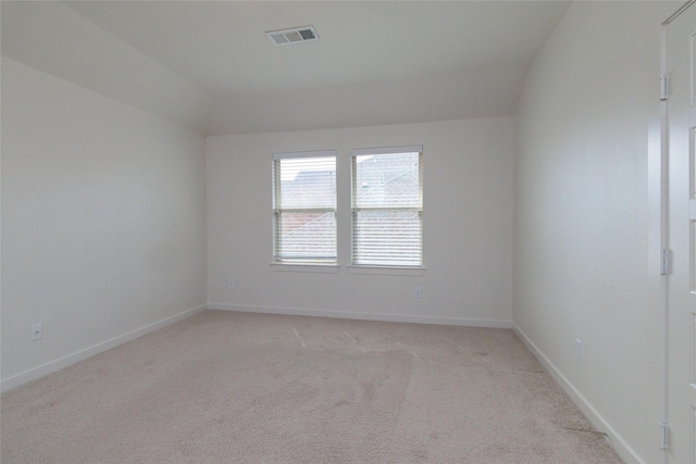 unfurnished room featuring baseboards, visible vents, and light colored carpet