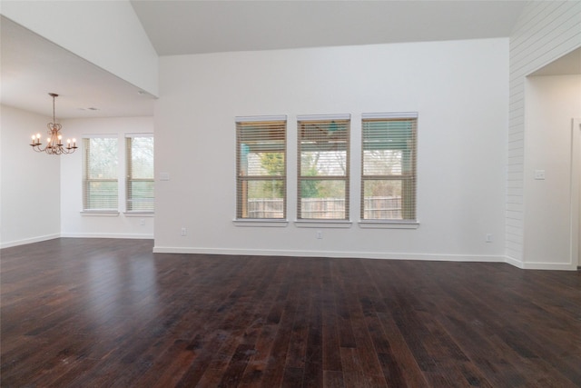 unfurnished room with a chandelier, dark wood-style flooring, and baseboards