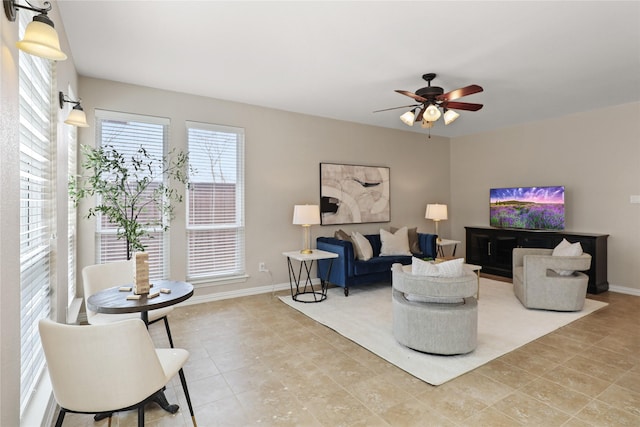 tiled living room with baseboards and ceiling fan