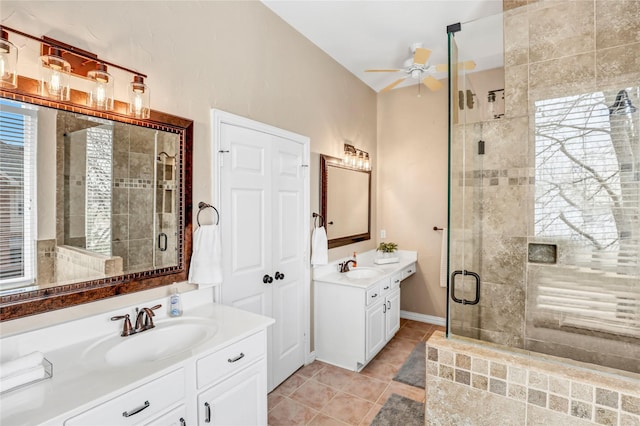 full bath featuring ceiling fan, a shower stall, tile patterned flooring, and a sink