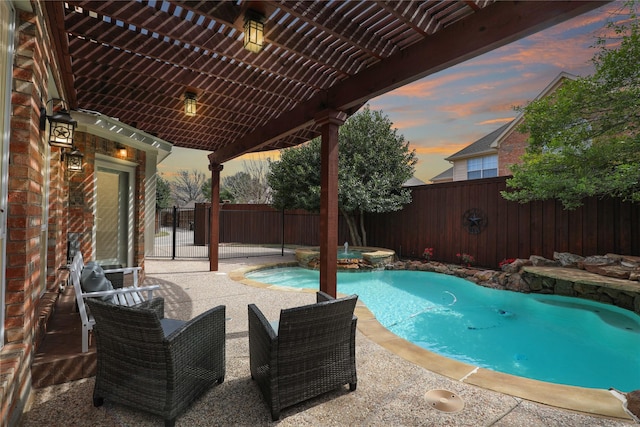 pool at dusk with a pool with connected hot tub, a patio, a pergola, and a fenced backyard