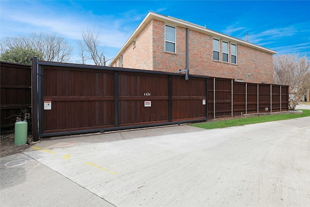 rear view of house with brick siding and fence