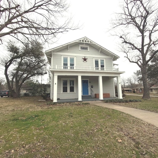 view of front facade featuring covered porch and a front lawn