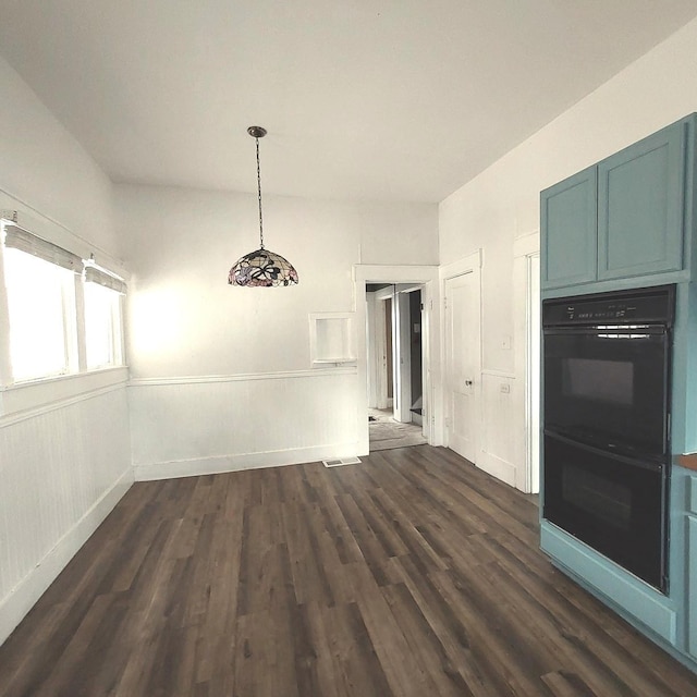 unfurnished dining area featuring dark wood-style flooring