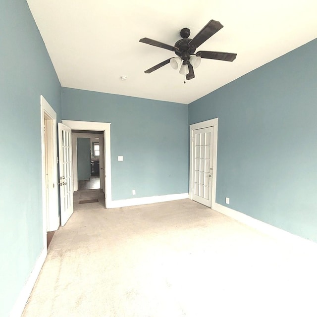 unfurnished bedroom with concrete flooring, ceiling fan, and baseboards