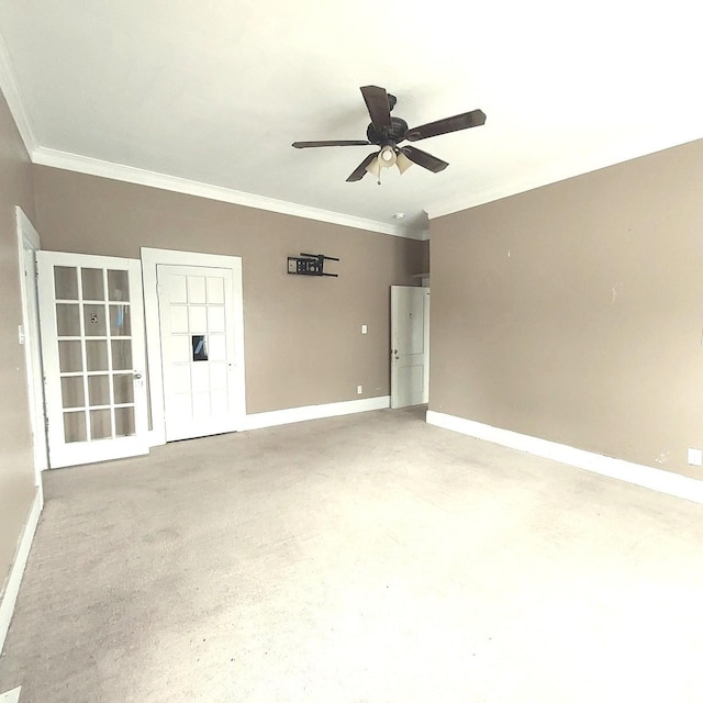 unfurnished room with ornamental molding, concrete flooring, ceiling fan, and baseboards