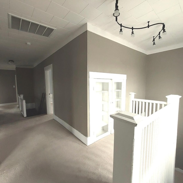 corridor featuring light carpet, baseboards, visible vents, and an upstairs landing