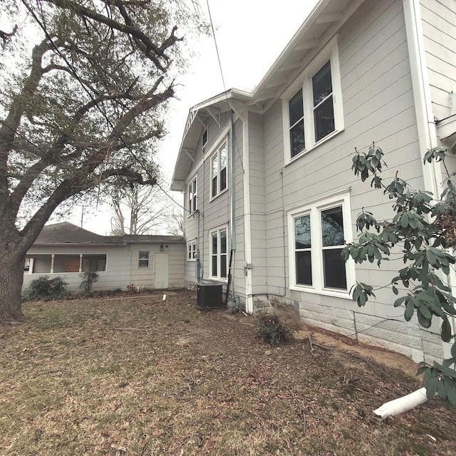 view of side of home with central AC unit