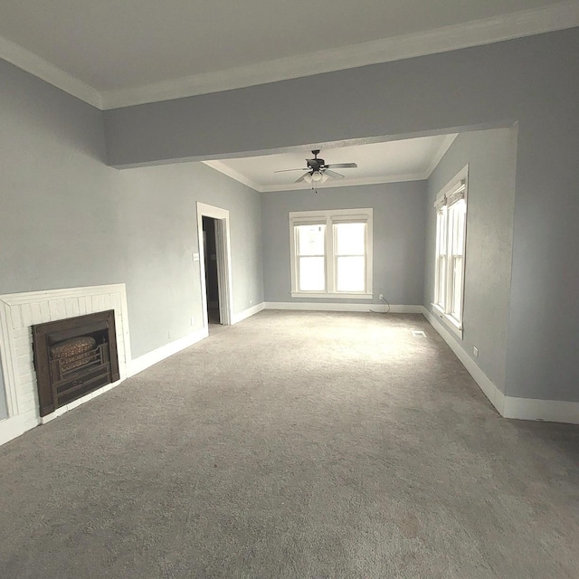 unfurnished living room with carpet floors, baseboards, a fireplace, and ornamental molding