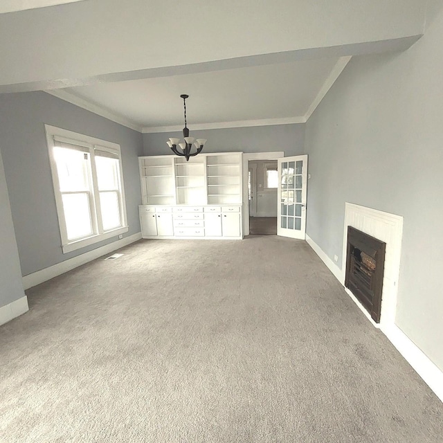 unfurnished living room featuring a chandelier, a fireplace, ornamental molding, and carpet floors