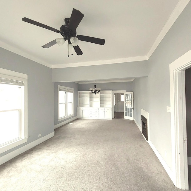 unfurnished living room with carpet, a fireplace, baseboards, and crown molding