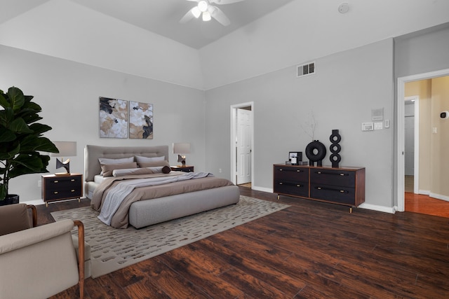 bedroom with baseboards, visible vents, a ceiling fan, lofted ceiling, and wood finished floors