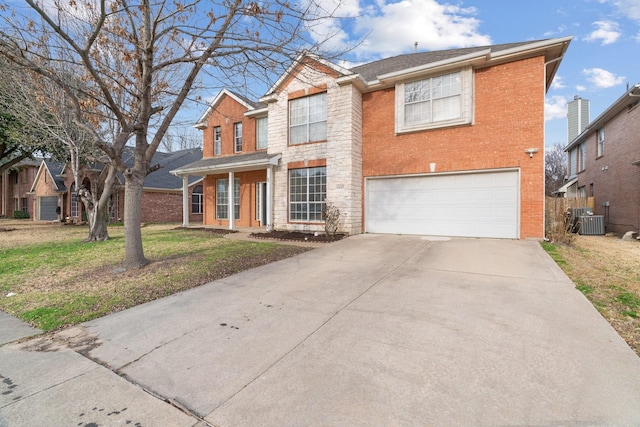 traditional home with an attached garage, brick siding, fence, concrete driveway, and a front yard