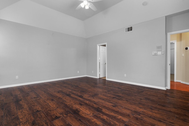 unfurnished room featuring dark wood finished floors, visible vents, a ceiling fan, vaulted ceiling, and baseboards