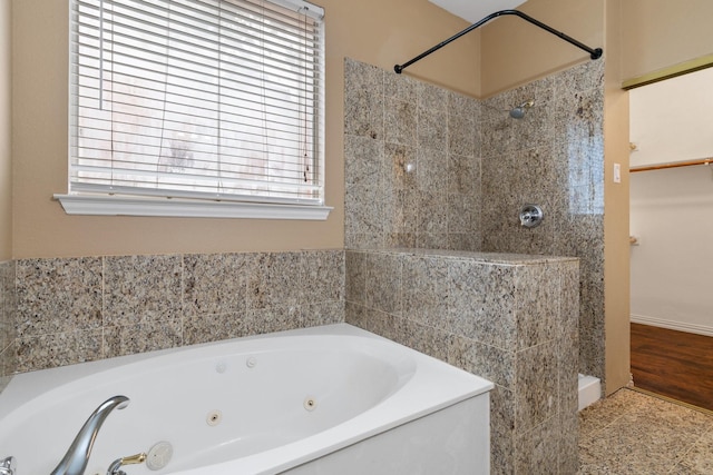 full bath with a whirlpool tub and tiled shower