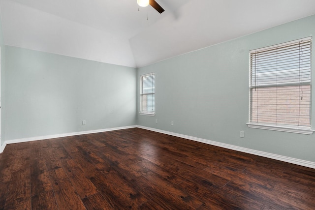 empty room featuring lofted ceiling, ceiling fan, wood finished floors, and baseboards