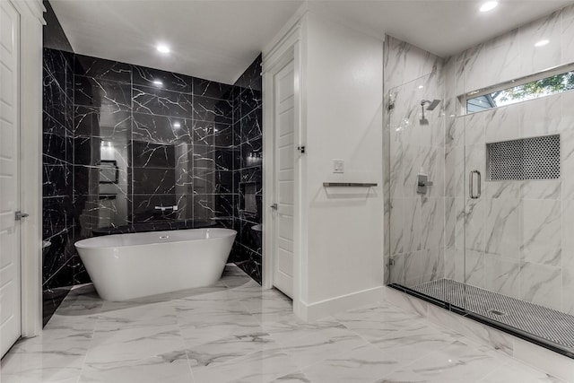 full bathroom featuring marble finish floor, a freestanding tub, a marble finish shower, and recessed lighting