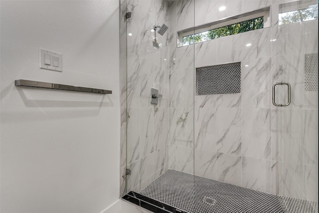 full bathroom featuring a marble finish shower