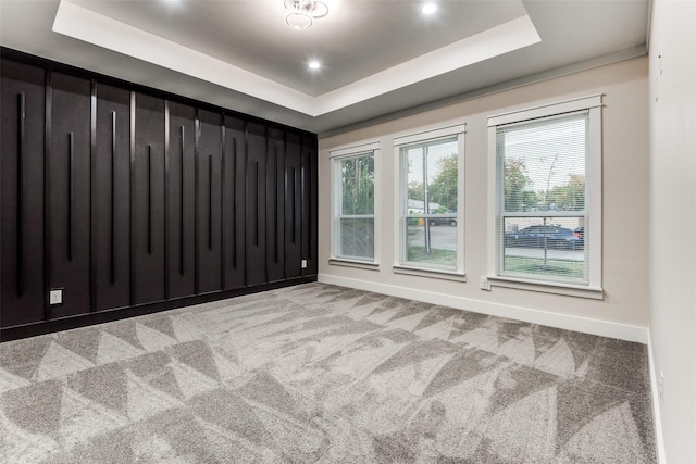 empty room with recessed lighting, carpet, a raised ceiling, and baseboards