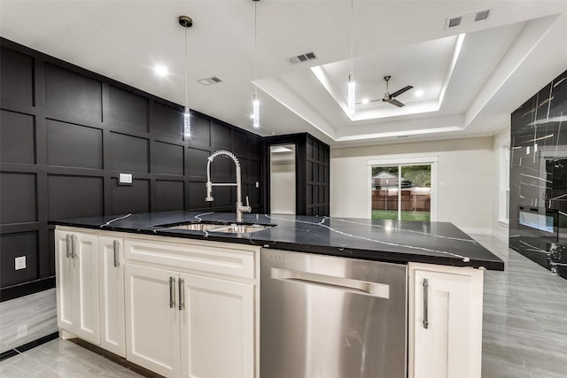 kitchen with a decorative wall, a sink, visible vents, stainless steel dishwasher, and a raised ceiling