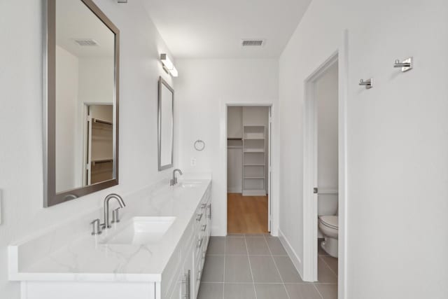 bathroom featuring visible vents, a sink, and toilet