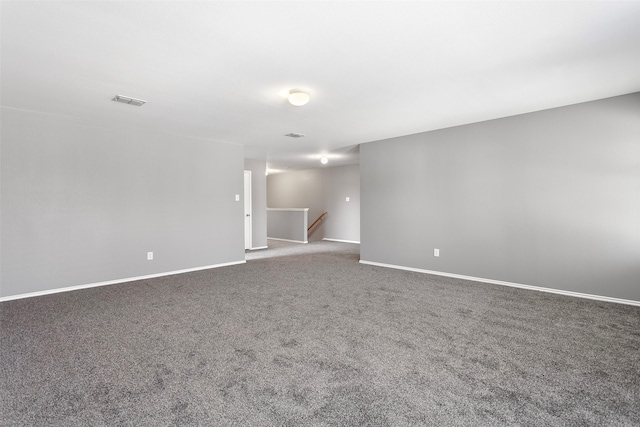 carpeted empty room with visible vents and baseboards