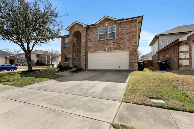 traditional-style home with concrete driveway, an attached garage, brick siding, and a front lawn