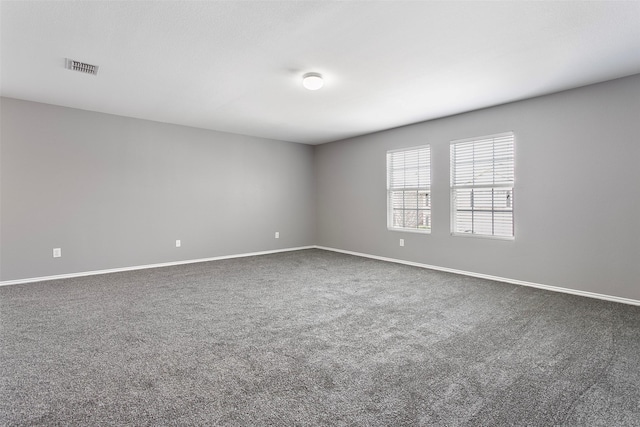 spare room with baseboards, visible vents, and carpet floors