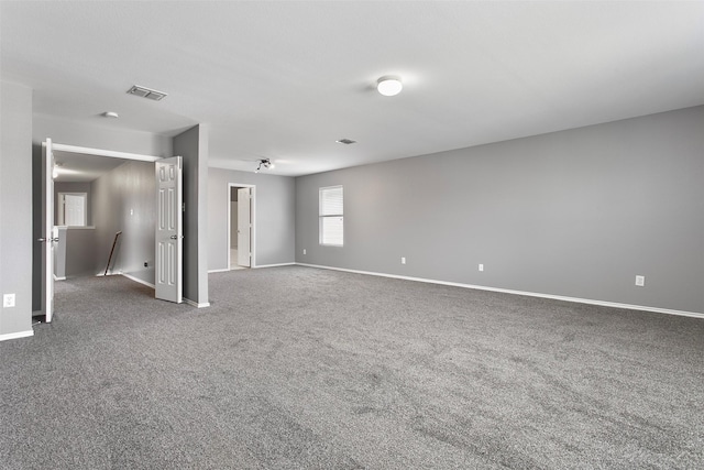 carpeted empty room featuring visible vents and baseboards