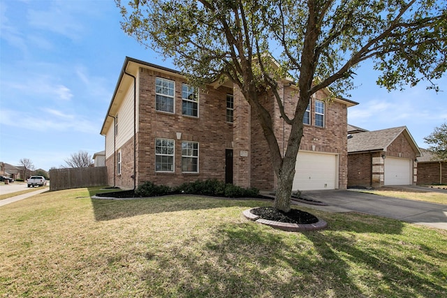 traditional home with a front yard, fence, a garage, aphalt driveway, and brick siding