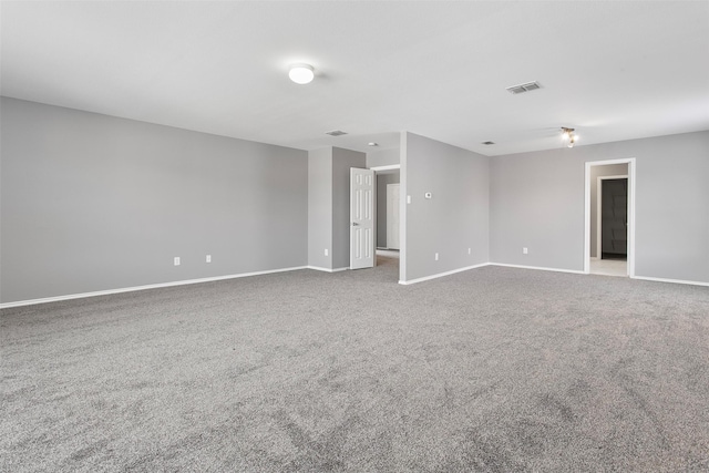 carpeted empty room with visible vents and baseboards