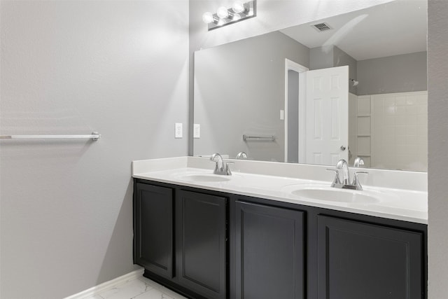 full bath featuring double vanity, visible vents, marble finish floor, and a sink