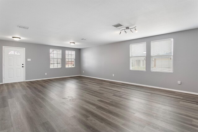 kitchen with dark countertops, white cabinets, visible vents, and stainless steel appliances