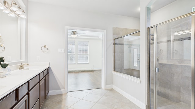 full bathroom with double vanity, tile patterned flooring, a sink, and a shower stall