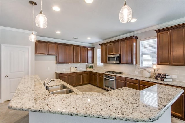 kitchen featuring appliances with stainless steel finishes, a sink, a large island with sink, and crown molding