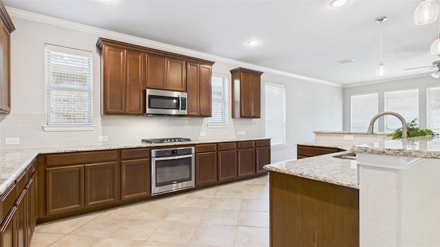 kitchen featuring a sink, appliances with stainless steel finishes, backsplash, and ornamental molding