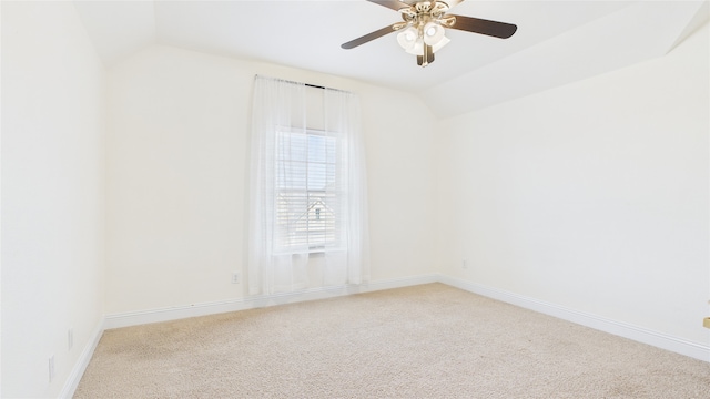 unfurnished room featuring a ceiling fan, baseboards, vaulted ceiling, and carpet flooring