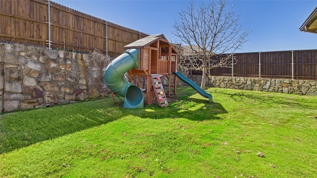 view of play area featuring a fenced backyard and a yard